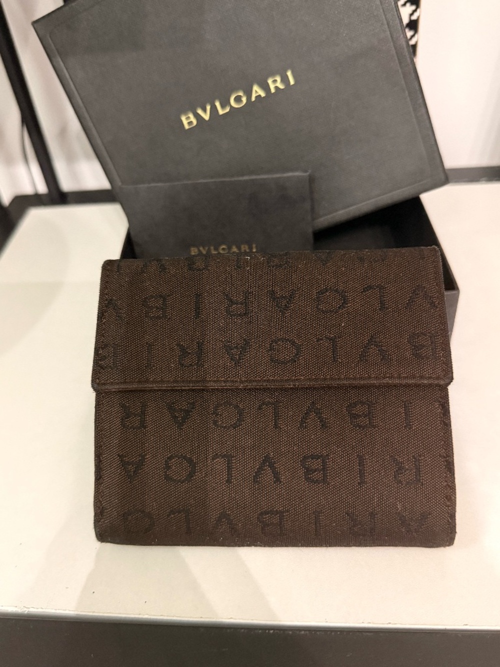 Bvlgari compact wallet featuring the signature Logo Mania monogram fabric in dar